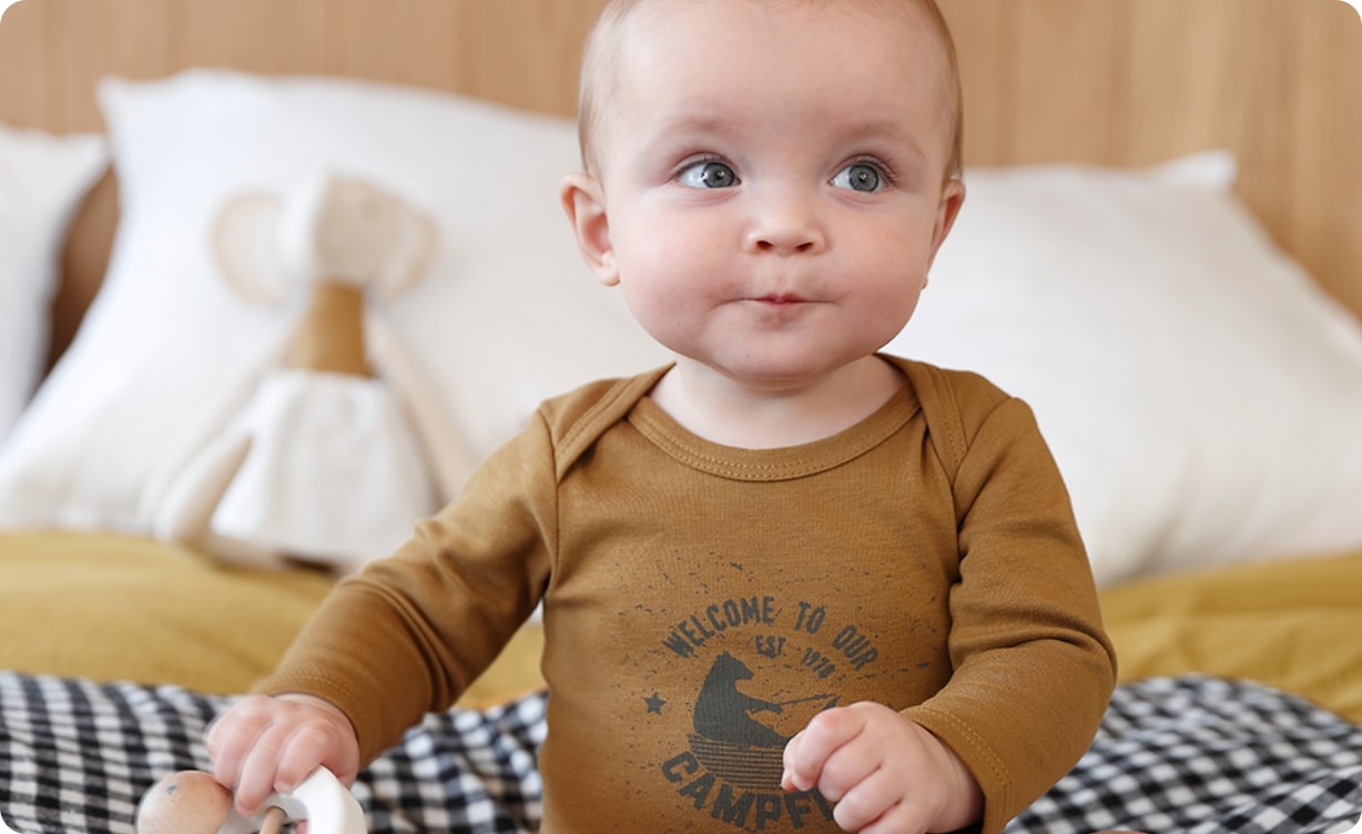 Baby mit Body mit Schlupföffnung